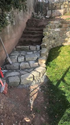 there is a pile of rocks on the side of this house that has been dug up