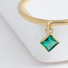 Description Delicate 18k yellow gold ring with a square-shaped emerald hanging from the band, swinging like a pendant on your finger whenever you move. This emerald is of a beautiful vivid green color. Emerald is the birthstone of May. Details Emerald – Approximately 4 mm x 4 mm (diagonally)18k Yellow Gold Made in Taiwan *Please note that due to the natural quality of the stones, there may be inclusions, cracks, or minor scratches on the stone. The stone that you receive may not be identical to the one shown in the pictures as each stone is unique. Feel free to contact us at any time if you have any questions. *Special order will take a minimum of 8 weeks. Exact delivery date will be communicated through email once the order is placed. There might be additional fee for increasing the size Green Single Diamond Jewelry For Promise Ring, Green Single Diamond Promise Ring Jewelry, 14k Gold Green Jewelry With Single Diamond, Square Cut Emerald Jewelry In Yellow Gold, Minimalist Rectangular Emerald Jewelry, 14k Gold Square Cut Emerald Ring, Classic Square Cut Emerald Jewelry, Green Princess Cut 14k Gold Jewelry, Classic Square-cut Emerald Jewelry