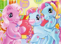 two pink and blue ponies standing next to each other in front of a carousel