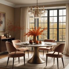 a dining room table with four chairs and a chandelier hanging from the ceiling