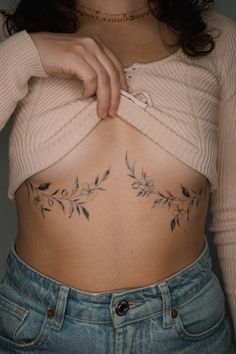 a woman with tattoos on her stomach