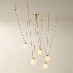 five light fixtures hanging from the ceiling in a room with white walls and flooring