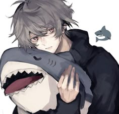 a man holding a shark in his arms with an angry look on it's face