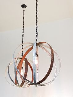 a chandelier hanging from a ceiling with three rings attached to the lightshade