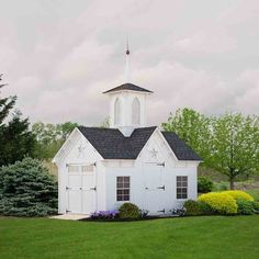 a small white church with a steeple on top