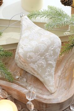 a white christmas ornament sitting on top of a wooden table