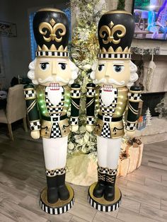 two large nutcrackers standing next to each other in front of a christmas tree