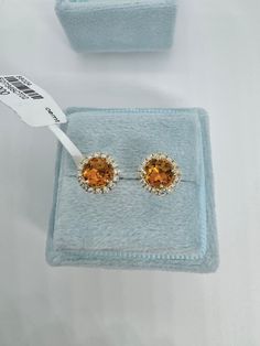 Beautiful Round Halo Citrine and Diamond Stud Earrings Yellow Gold.  Simple and classy earrings.  Excellent craftsmanship, the halo of diamonds frame the citrine beautifully.  The diamonds are very sparkling.  The halo measures about 7.7mm.   The push backings have 2 security notches for a secure fit.  The backs are big and strong.   Genuine citrine 5mm round cuts  Total weight: 0.87 carats Genuine round brilliant cut diamonds  Total weight: 0.23 Clarity: SI Color: G Solid 18K Yellow Gold 2.13 grams  Comes with gift box AT1700 * We have been in the wholesale Jewelry business for over 30 years serving the community at the same location.  All diamonds we use are natural stones and fine quality gold.  Absolutely NO clarity enhanced or treated diamonds. Our jewelry pieces are handcrafted with Yellow Gold Topaz Earrings, Round Shape, Yellow Gold Halo Cluster Earrings For Wedding, Formal Topaz Earrings With Prong Setting, Luxury Citrine Earrings, Fine Jewelry Topaz Earrings For Wedding, Formal Yellow Gold Cluster Earrings With Halo Setting, Fine Jewelry Topaz Earrings With Prong Setting, Anniversary Citrine Earrings With Prong Setting, Citrine Fine Jewelry Earrings For Wedding