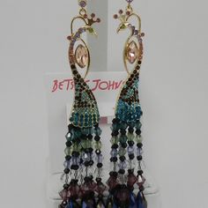 Chandler Earrings Feature Mixed Multi Coloring Pave Stone And Beads That Leads To A Peacock Silhouette. Antique Gold Plating Lever Back. Approximately Measurements - Width 1” - Height 4.35” - Weight 0.4 Ozgarner Attention When You Complement Your Look With These Stunning Earrings. Chandler Earrings Feature Mixed Multi Coloring Pave Stone And Beads That Leads To A Peacock Silhouette. Antique Gold Plating Lever Back. Peacock Silhouette, Chandler Earrings, Betsey Johnson Jewelry, Stunning Earrings, Chandelier Earrings, Gold Plating, Antique Gold, Betsey Johnson, Jewelry Inspiration