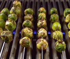 the brussel sprouts are being cooked on the grill