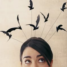 a woman with birds flying over her head and the words bird on top of her head