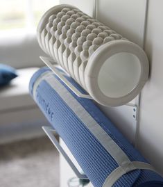 a close up of a blue and white object on a wall near a bed in a room