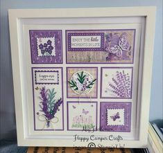 a purple and white framed artwork with flowers