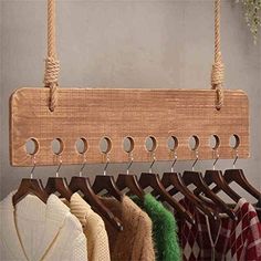 a wooden coat rack with several coats hanging from it