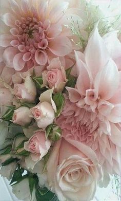 a bouquet of pink flowers sitting on top of a table