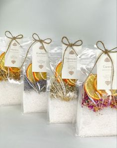 four bags filled with different types of spices and seasoning on top of each other