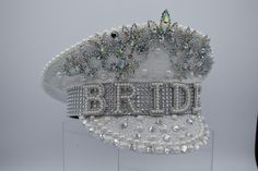 Sparkle, shine, and strut your fabulous self in this gorgeous White Sequin Captain's BRIDE hat with Gem Crown. Featuring gorgeous faux gems and pearls with silver rhinestones accenting the BRIDE banner. Hat stands about 7 inches tall with gem include. The cap is 11 inches long and 10.5 inches wide. The hat fits approximately 58 cm and includes an elastic band inside the opening for a customized fit. Great for Weddings, Bachelorette Parties, Festivals, Halloween, and more! For ages 14 and older. Spot clean only. 🌟Gorgeous White Sequin Captain's BRIDE hat with Gem Crown. Hat stands about 7 inches tall with gem included. 🌟Featuring gorgeous faux gems and pearls with silver rhinestones accenting the BRIDE banner. 🌟The hat fits approximately 58 cm and includes an elastic band inside the open Fitted Mini Party Cap, Fitted Mini Cap For Party, Fitted Mini Cap For Parties, Fitted Cap Mini Hat For Wedding, Gender Fluid, Bride Hat, Crown Hat, Hat Fits, Crown Wedding