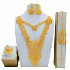 a gold jewelry set on display in a box