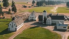 an aerial view of a farm with several barns