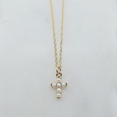 This Pearl Cross Necklace is a classic take on a timeless piece. The pearls are superbly feminine and the cross is such a timeless symbol of faith and hope. Details: Pearl measures about 2mm each 14k gold chain adjustable 16 inches to 18 inches Available in 14k rose gold, 14k yellow gold or 14k white gold Free Shipping on Domestic Orders Materials: Pearl, 14k gold Cross Necklace With Pearls, Pearl Cross Necklace, Faith And Hope, Necklace With Pearls, Timeless Symbol, Faith Hope, The Cross, Timeless Pieces, Gold Chain