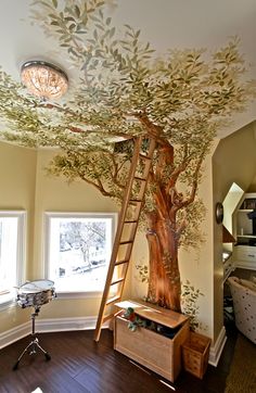 a room with a tree painted on the ceiling and ladder up to it's roof