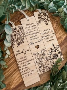 two wooden bookmarks with flowers on them and the words thank you for the wedding