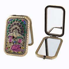 an open compact mirror sitting on top of a white table next to a small case