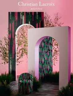 a pink and green room with two chairs in front of an arch that has trees growing out of it