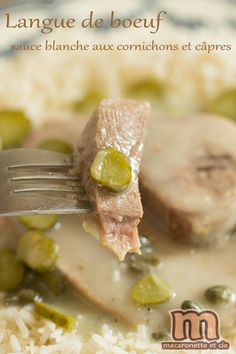 a close up of a plate of food with rice and meat on it that has a fork in it