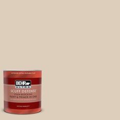 a can of behr ultra paint and primer on a gray background with the words,