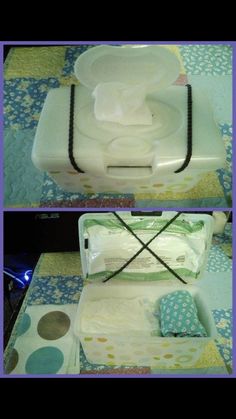 an open suitcase filled with baby diapers on top of a blue and white blanket