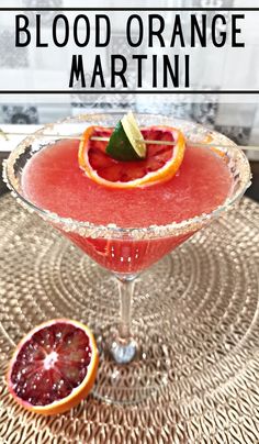 blood orange martini is garnished with an orange slice