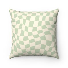 a green and white checkered pillow on a white background