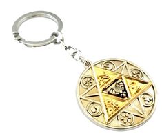 a gold keychain with a masonic symbol on the front and back side of it