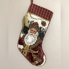 a christmas stocking hanging on the wall with a santa claus face and leopard print