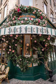 a store front with pink flowers on it's windows and the words jack's wife frieda