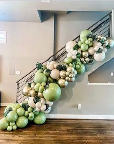 a staircase decorated with green and white balloons