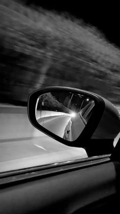 a car's side view mirror is shown in black and white