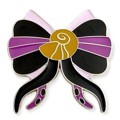 a black, purple and gold bow brooch with an embellishment on it