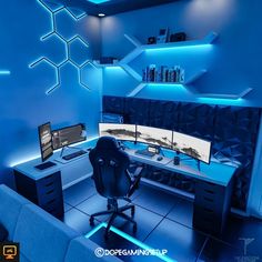 a computer desk with two monitors and a laptop on it in a room that has blue lighting