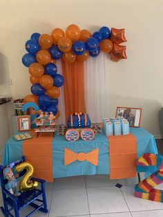 an orange and blue table topped with balloons