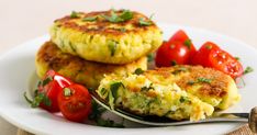 two crab cakes on a plate with tomatoes