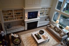 a living room filled with furniture and a flat screen tv mounted to the wall above a fireplace