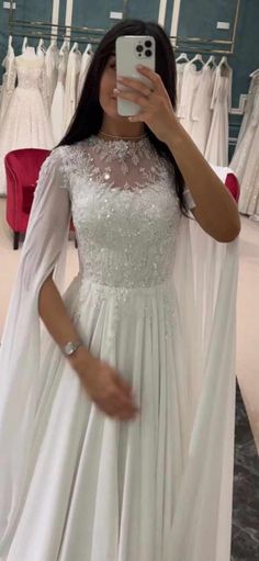 a woman taking a selfie while wearing a wedding dress