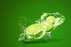 three limes with leaves splashing out of them on a bright green background,