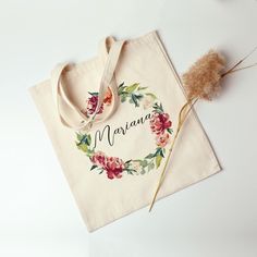 a tote bag with the word mama written on it next to some dried flowers