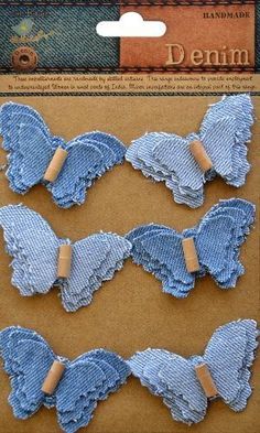 three pieces of blue fabric with wooden pins in the shape of angel wings on a cardboard package