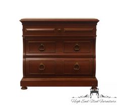 a wooden dresser with three drawers and two pulls on the bottom drawer, against a white background