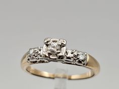 a diamond ring with three stones on it