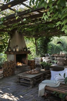 an outdoor fireplace and seating area in a garden